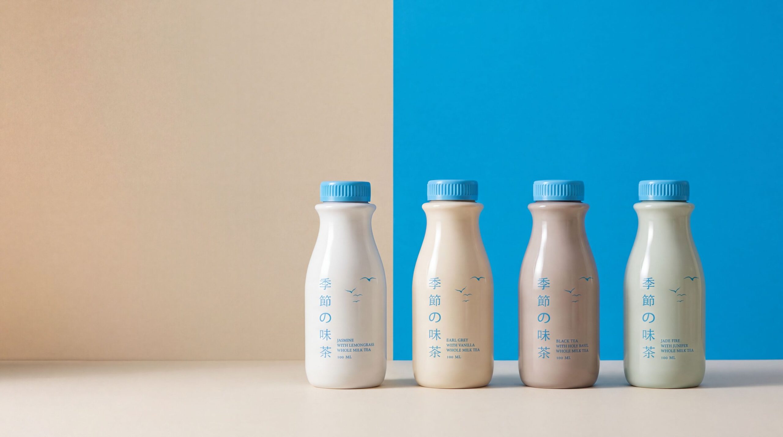 The four Seasons bottles standing where a sand wall meets a sky-blue wall