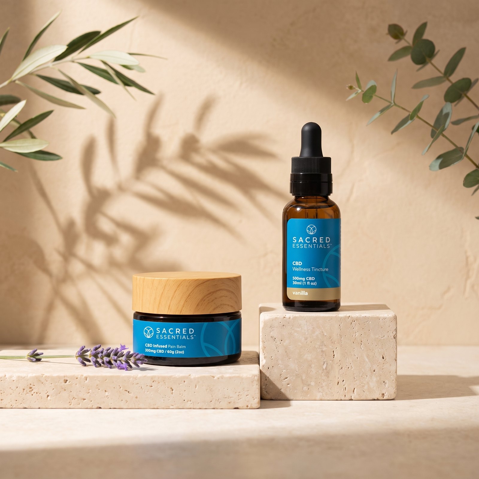 The Pain Balm and the Wellness Tincture on travertine in morning light